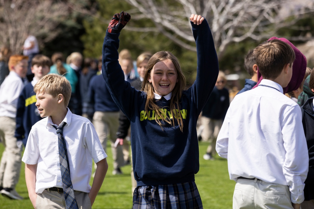Middle school student cheers in celebration.